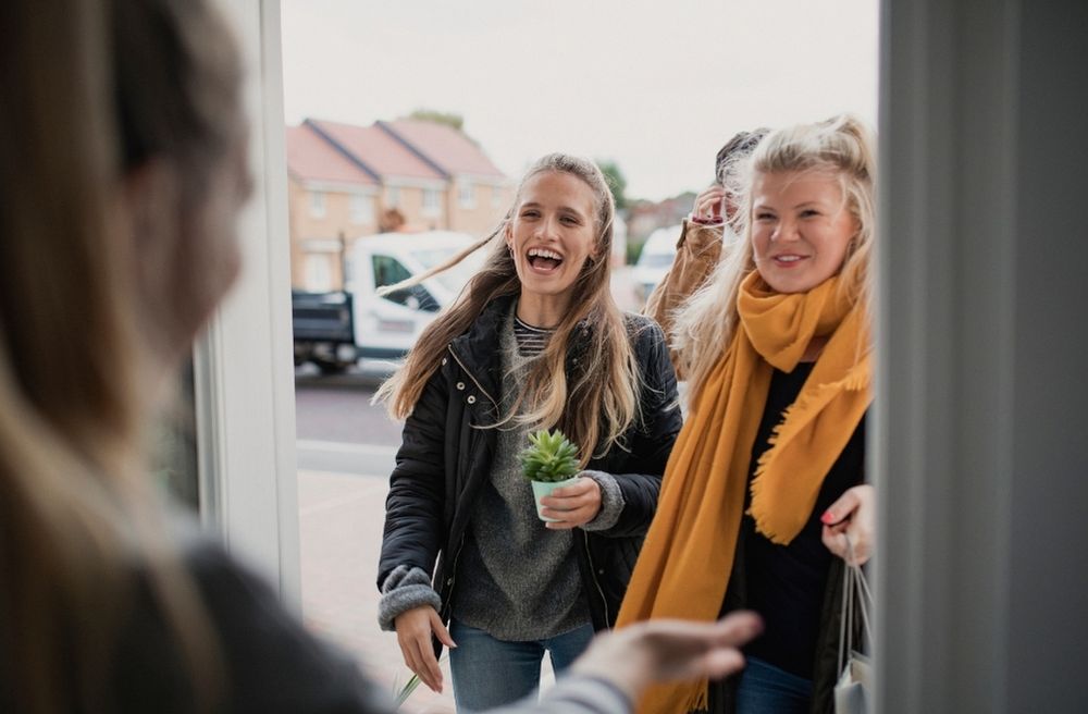 Host greeting guests at front door
