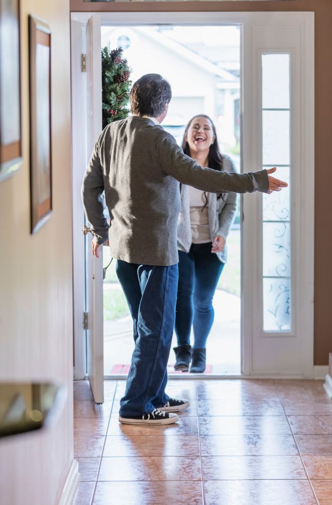 Host welcoming guests at front door