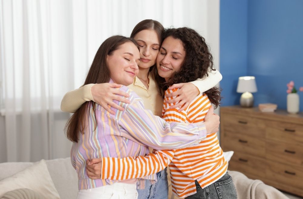 Warm hug between friends at home