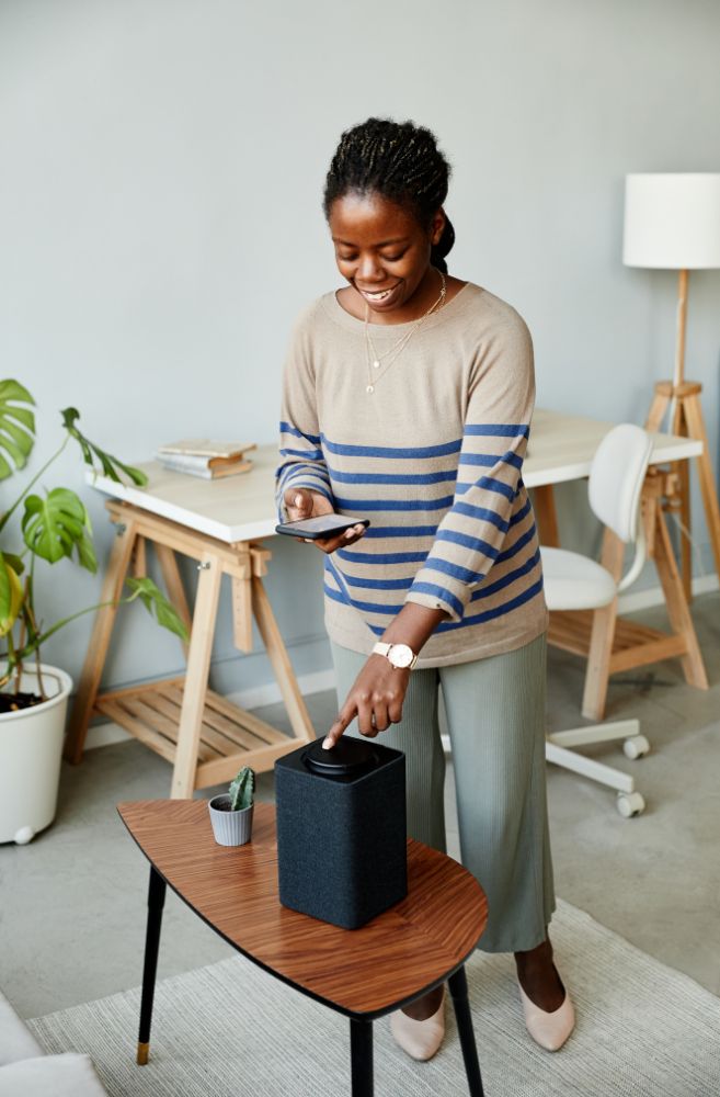 Woman adjusting Smart Speaker at Home