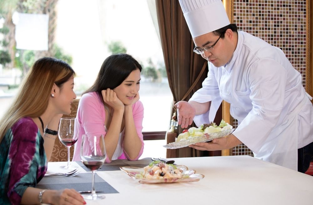 chef serving tasting menu
