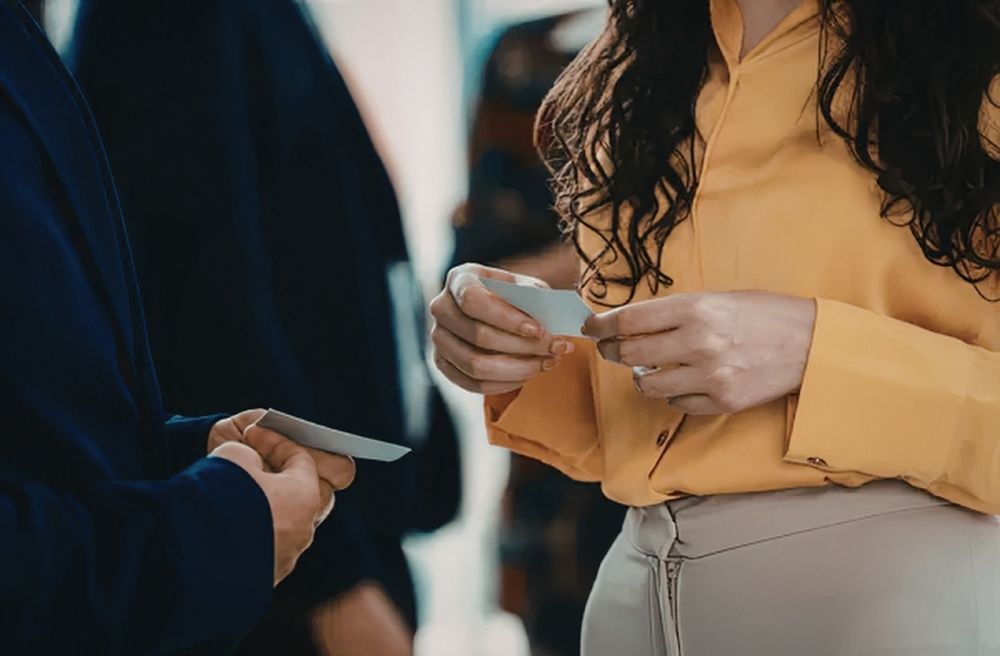 friends exchanging recipe cards