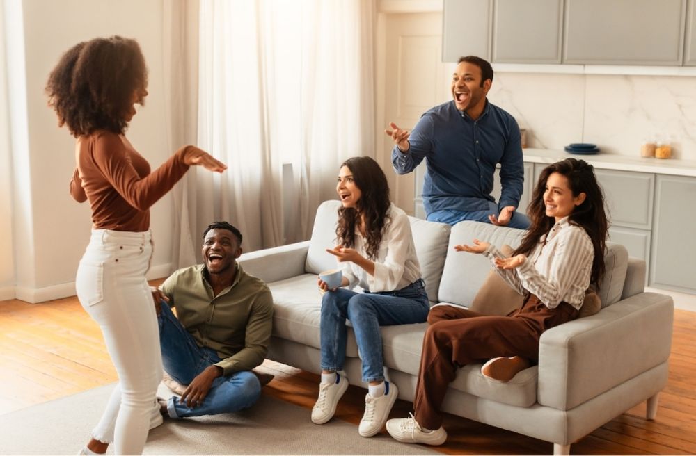 friends laughing comfortably at home gathering