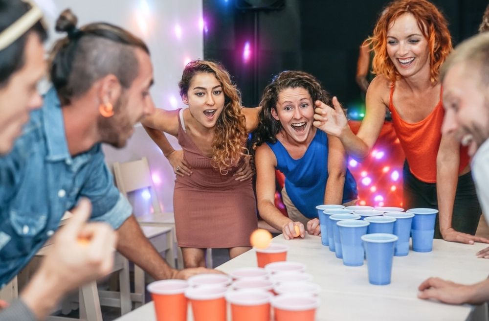 friends playing board game dinner party