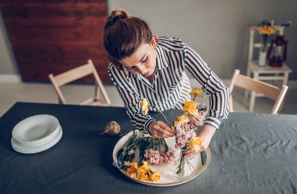 host adjusting dinner table