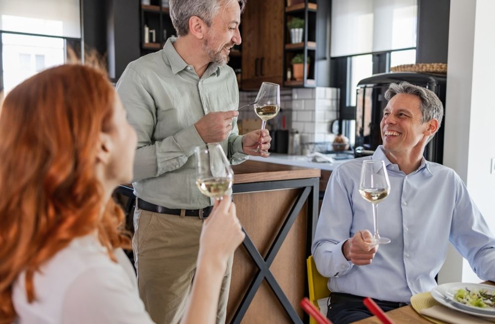 host observing guests during dinner party