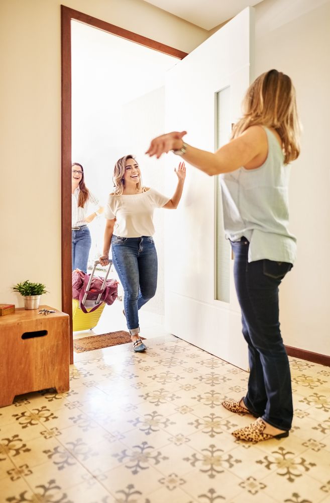 host welcoming guests at elegant home