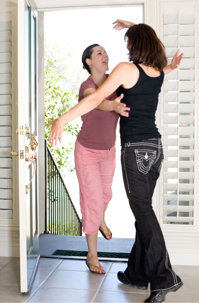 host welcoming guests at home