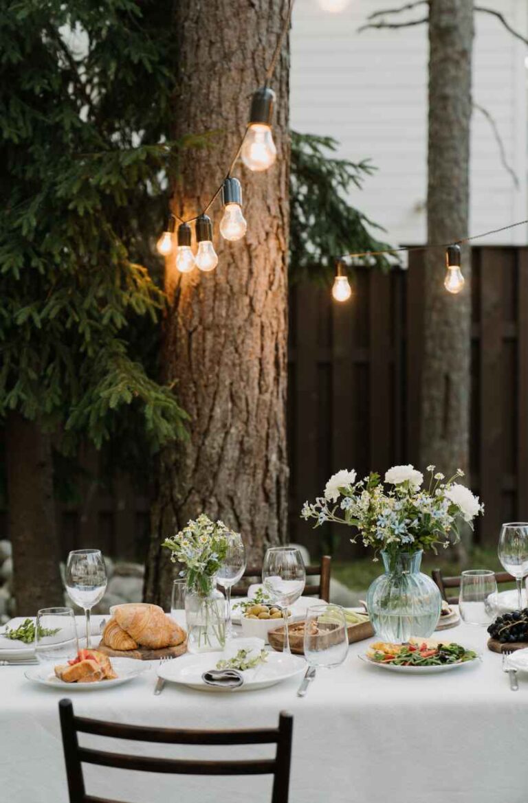 Elegant summer outdoor dinner party table with string lights
