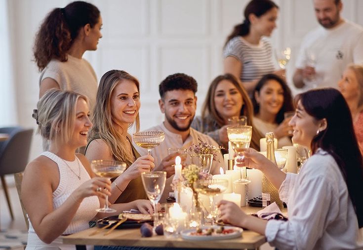 Guests sitting uncertainly at a dinner table