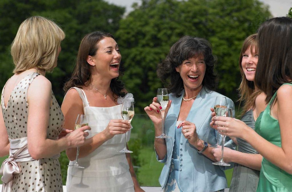Guests standing with drinks before dinner begins