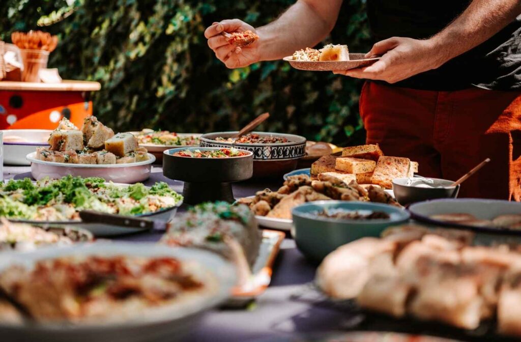 guest choosing food at dinner table