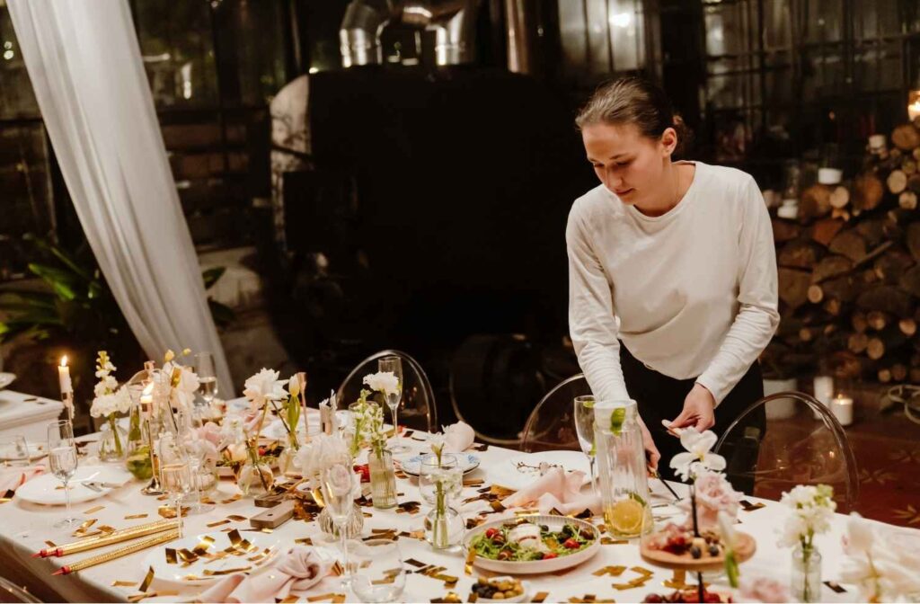 host clearing table after dinner party