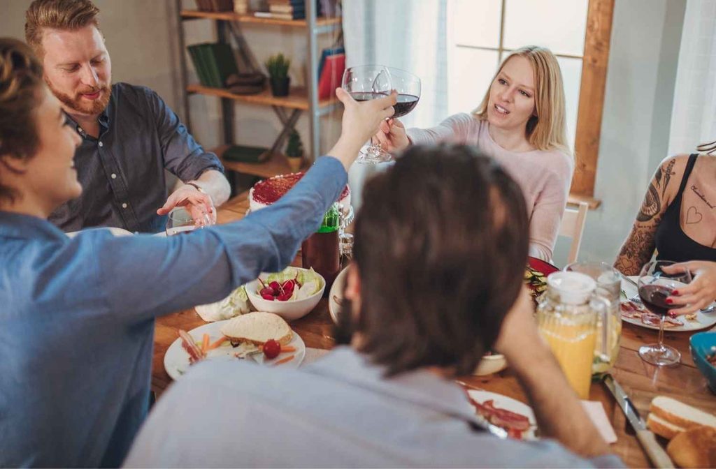 host enjoying dinner party with guests