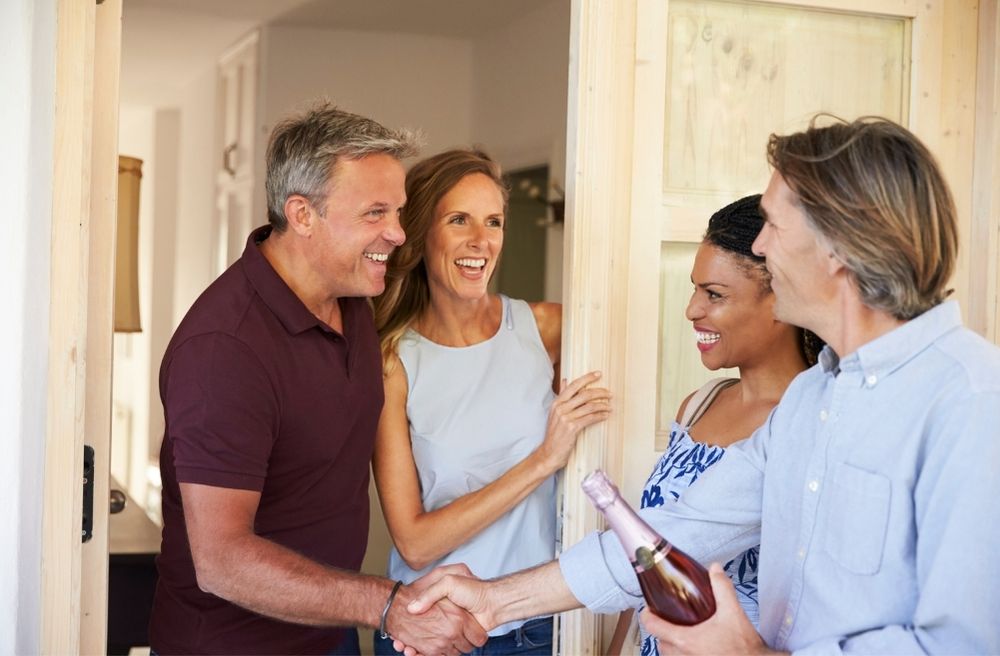 host greeting guests at front door