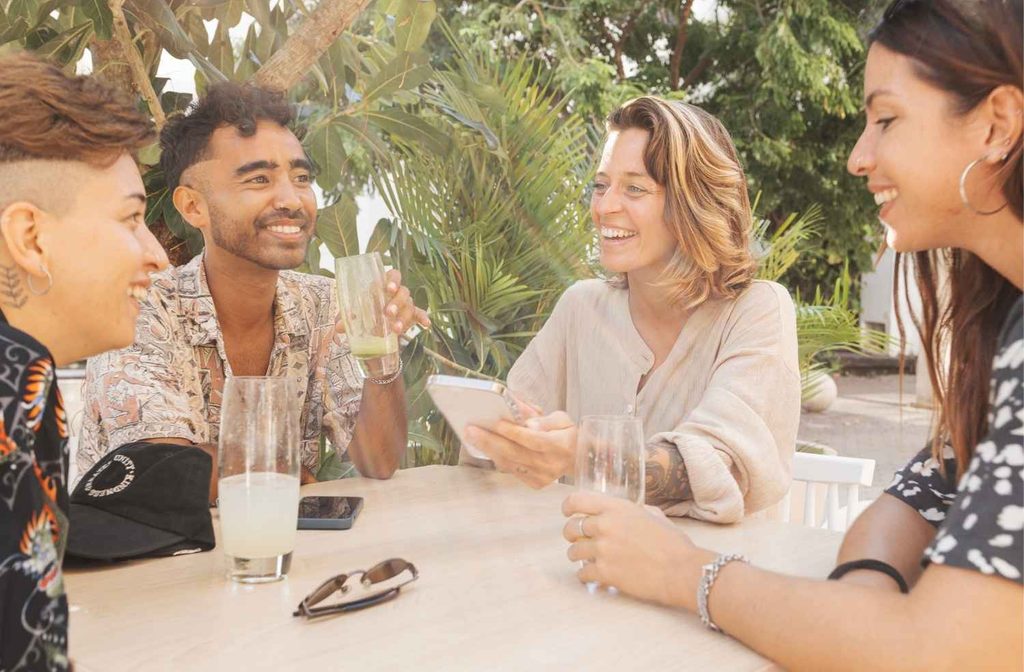host using phone while guests talking