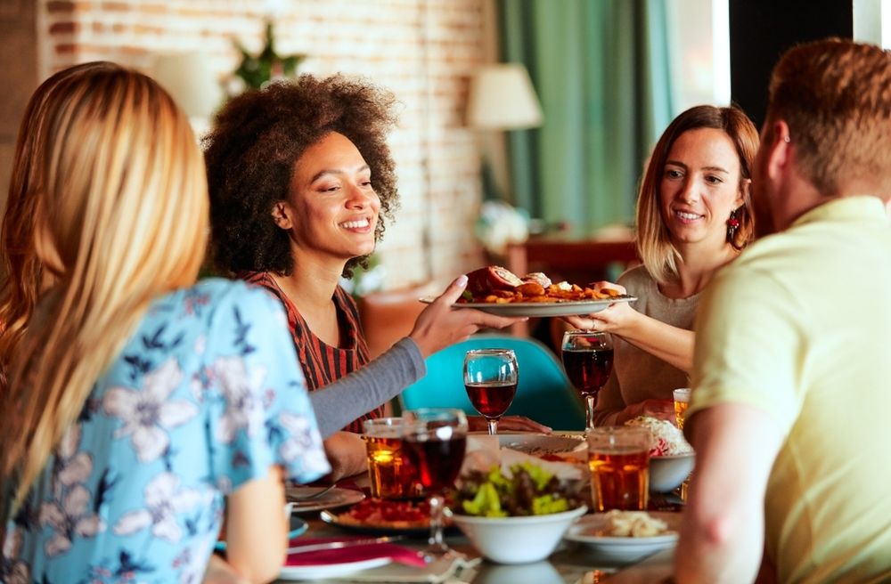 Friends casually gathering around a dining table