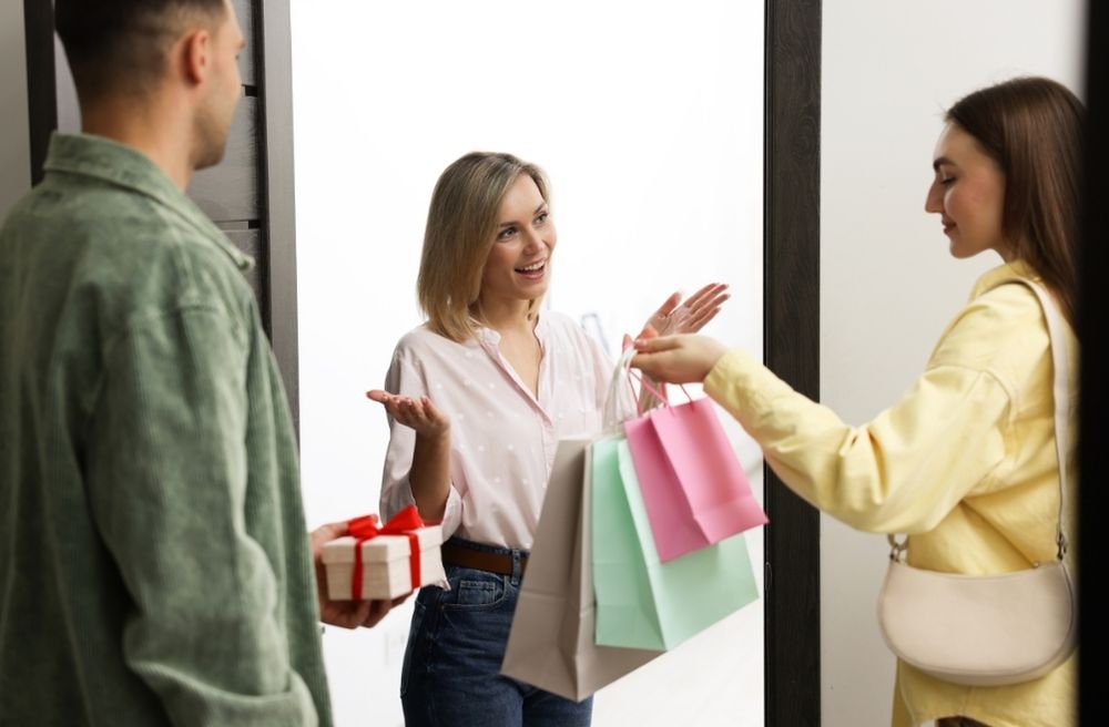 host welcoming guests at door